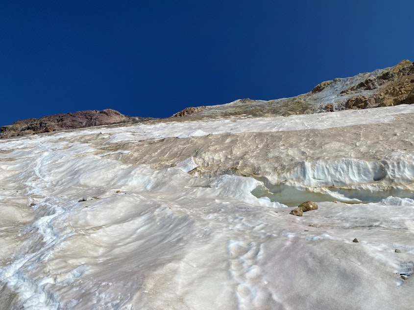 caption: Bare rock and fallen boulders on Mount Baker's Easton Glacier on Aug. 28, 2023