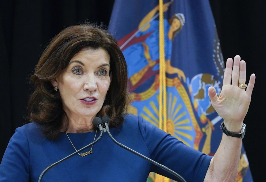 caption: New York Gov. Kathy Hochul shortened the quarantine period for many essential workers even as infections have surged because of the omicron variant.