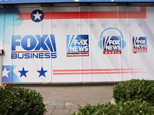 caption: The logos for Fox programs are displayed on the News Corp. building on Jan. 25, 2023 in New York City.