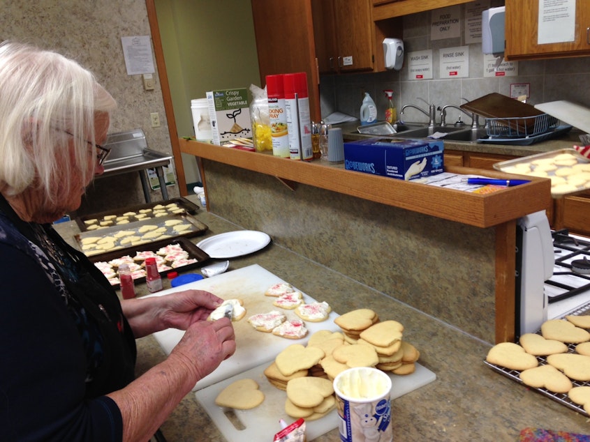 caption: Irma Erickson helps bake cookies for those affected by the Marysville-Pilchuck High School shootings.