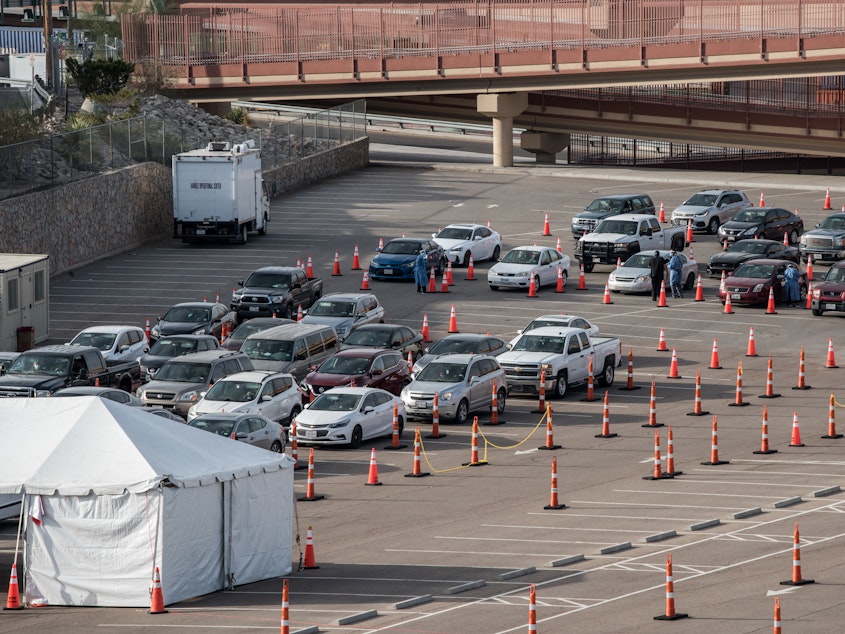 caption: Cars wait in line at a coronavirus testing site at the University of Texas at El Paso Saturday. As El Paso reports record numbers of active coronavirus cases, the Texas attorney general sued to block local shutdown orders.