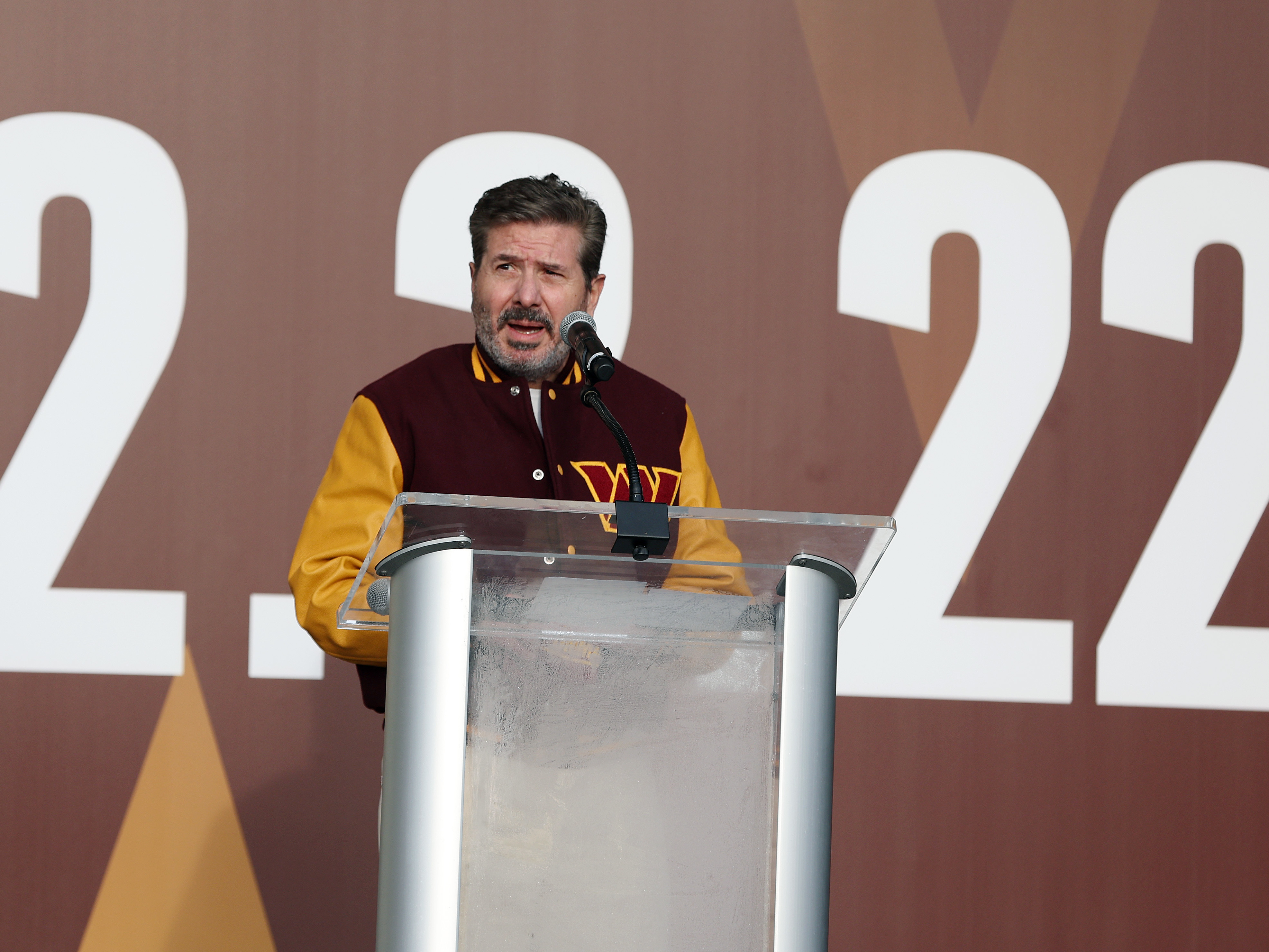 caption: Owner Dan Snyder speaks during the announcement of the Washington Football Team's name change to the Washington Commanders at FedExField on February 2, 2022 in Landover, Maryland.