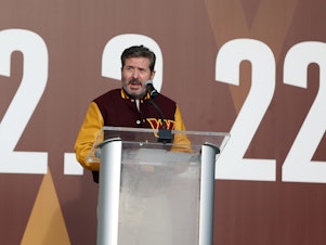 caption: Owner Dan Snyder speaks during the announcement of the Washington Football Team's name change to the Washington Commanders at FedExField on February 2, 2022 in Landover, Maryland.