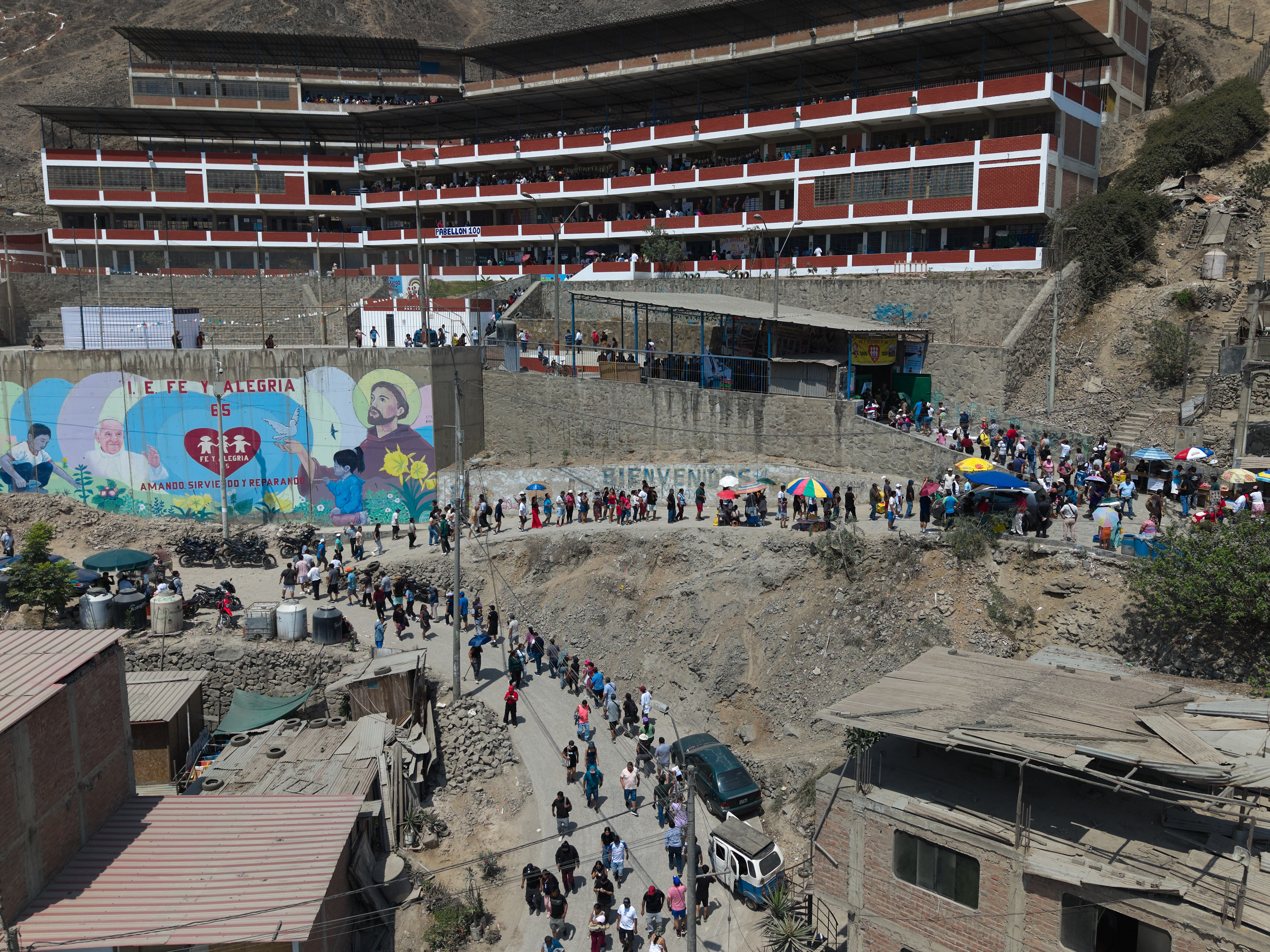 caption: Voters line up outside a polling station during general elections in Lima, Peru, Sunday, April 12, 2026.
