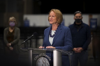 caption: Seattle mayor Jenny Durkan speaks to the press at a mass Covid-19 vaccination site set to open on Saturday on Wednesday, March 10, 2021, inside the Lumen Field Events Center in Seattle. The site will be the largest civilian-led vaccination site in the country.
