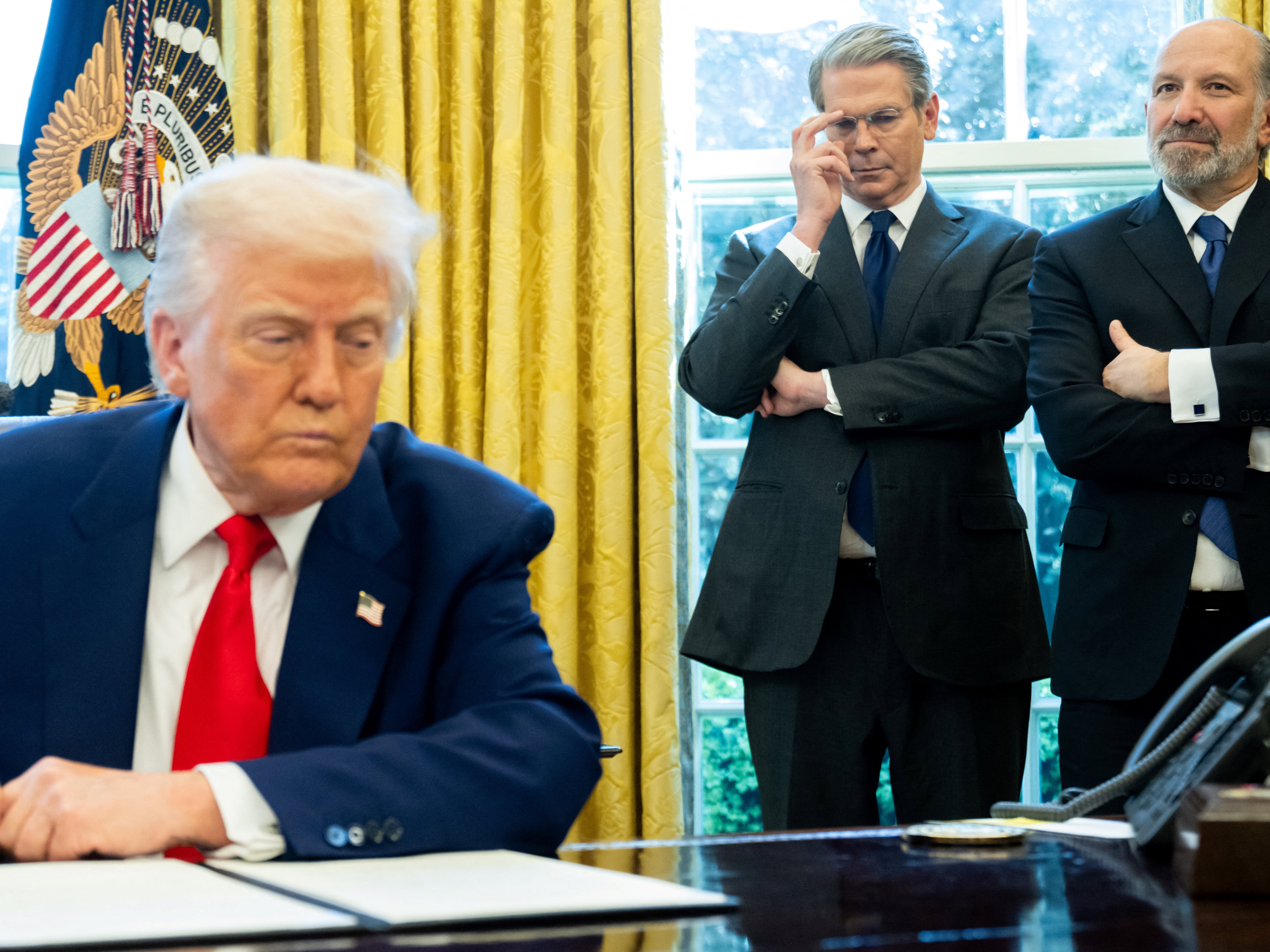 caption: Treasury Secretary Scott Bessent and Commerce Secretary Howard Lutnick with President Trump in the Oval Office on Wednesday.