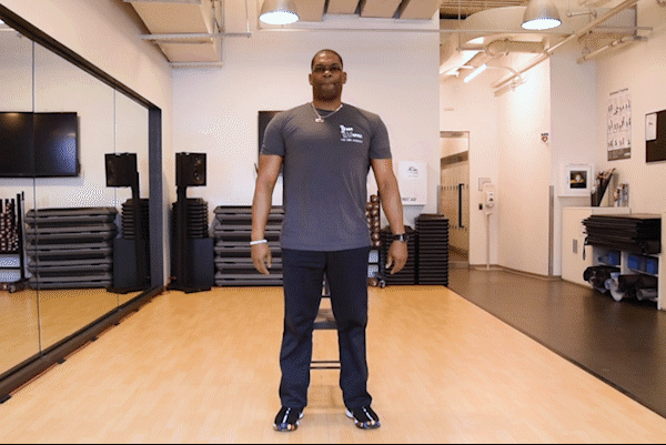 caption: If you're starting out, try squats in a chair, shown here. To challenge yourself more, lift one leg as you sit up and down.