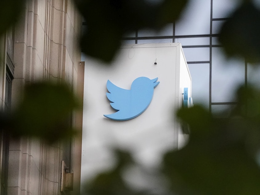 caption: A sign at Twitter headquarters is shown in San Francisco on Dec. 8, 2022.