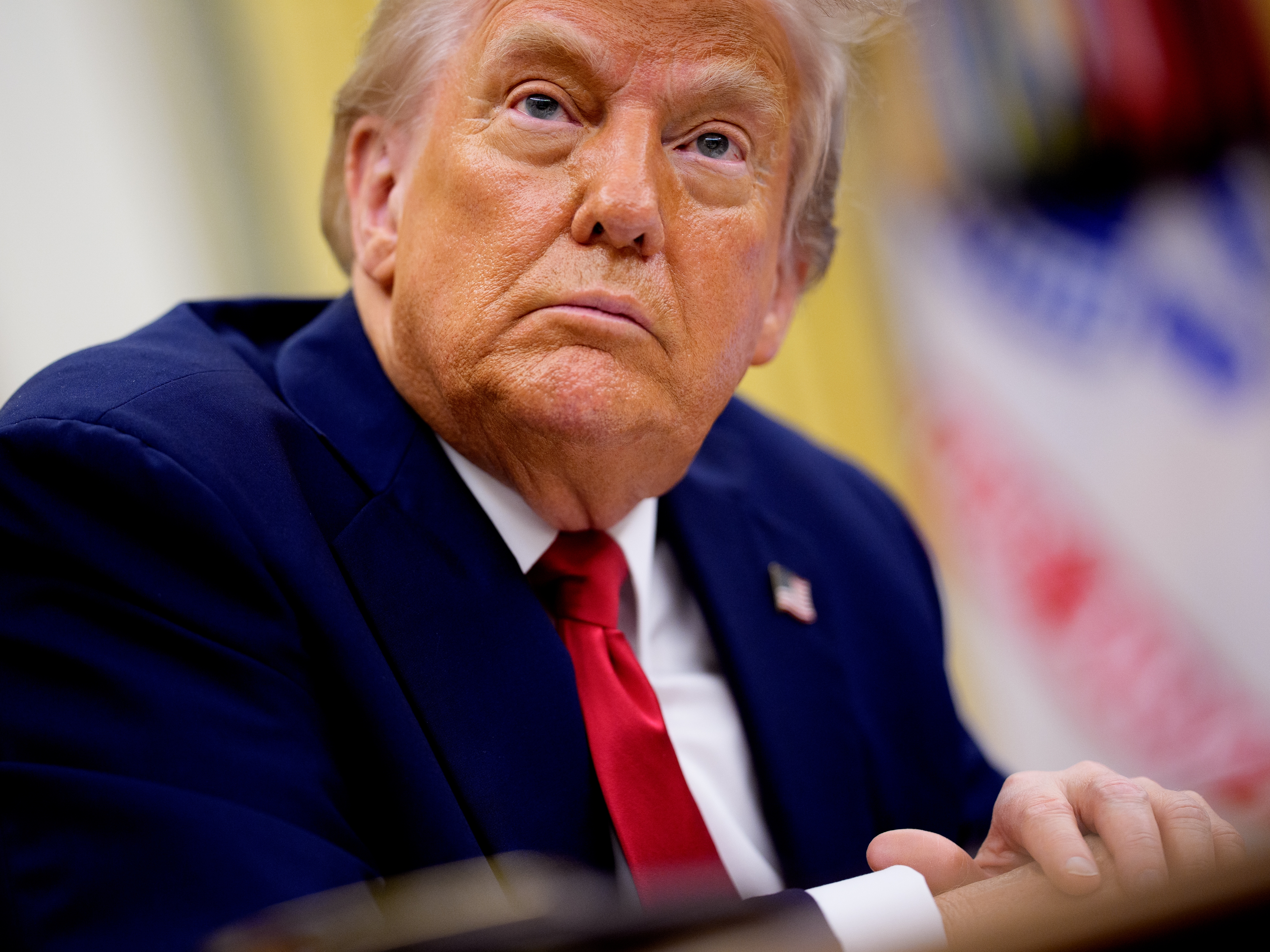 caption: President Trump takes questions from reporters during an event in the Oval Office of the White House on March 31, 2025.