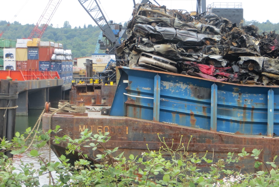 caption: Canadian scrap cars on a barge on June 27, 2018, a day after the barge spilled flaming cars into Seattle's Duwamish Waterway.