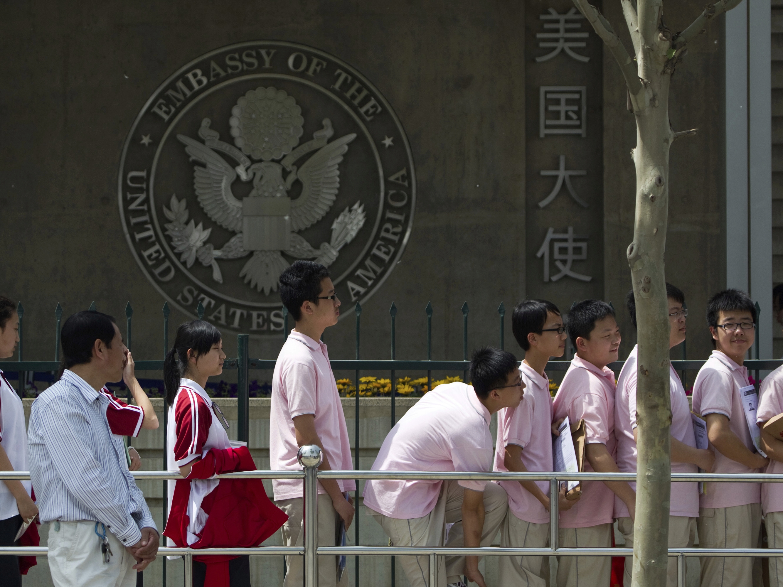 caption: Chinese students wait outside the U.S. Embassy for their visa application interviews, in Beijing on May 2, 2012.