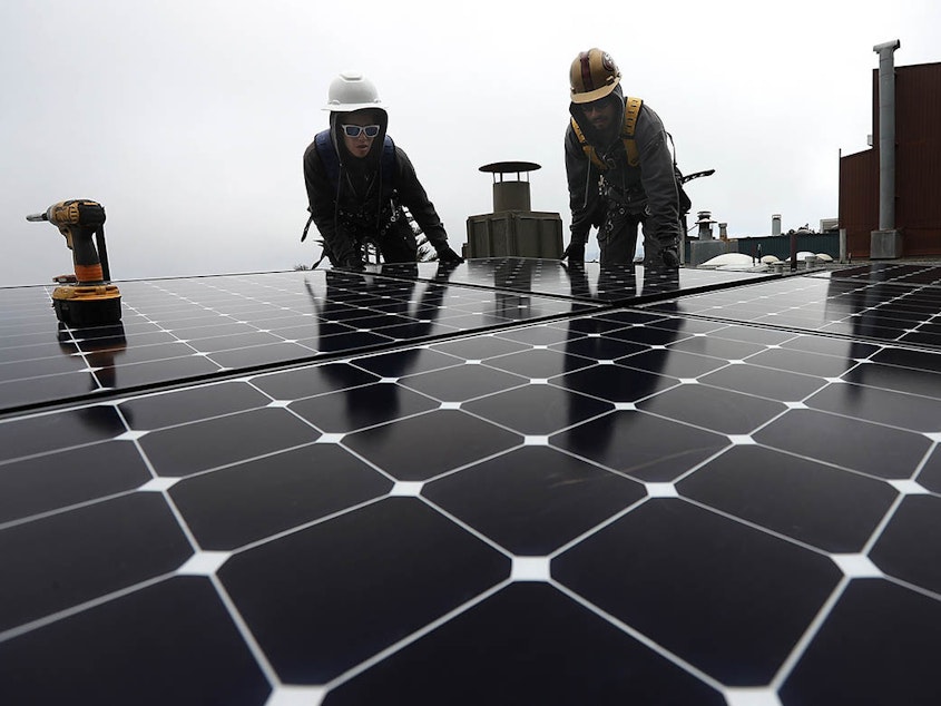 caption: The Build Back Better legislation included billions to accelerate clean energy like rooftop solar, but with the bill now stalled in Congress, cutting U.S. emissions will be tougher.