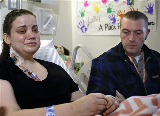 caption: Washington mudslide survivor Amanda Skorjanc, left, talks to the media with her partner Ty Suddarth at Harborview Medical Center, April 9, 2014, in Seattle. On March 22, Skorjanic said she was trapped in a pocket formed by her broken couch and pieces of her roof with her infant son.