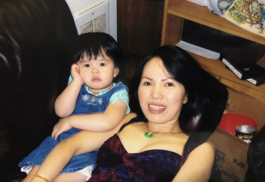 caption: Jennifer Nguyen (left) and her mom, Michell, lounge on the couch when Jennifer was a toddler. 