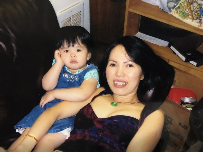 caption: Jennifer Nguyen (left) and her mom, Michell, lounge on the couch when Jennifer was a toddler. 
