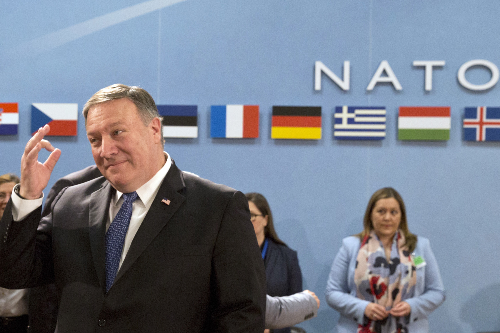 caption: U.S. Secretary of State Mike Pompeo, left, waits for the start of the North Atlantic Council at NATO headquarters in Brussels on Friday, April 27, 2018. (Virginia Mayo/AP)