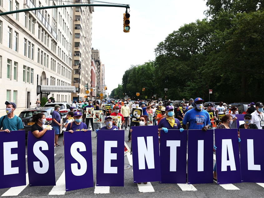 caption: Members of the 32BJ union participate in a "Strike for Black Lives" rally in New York City, one of the many demonstrations for racial and economic justice that took place across the U.S. on Monday.