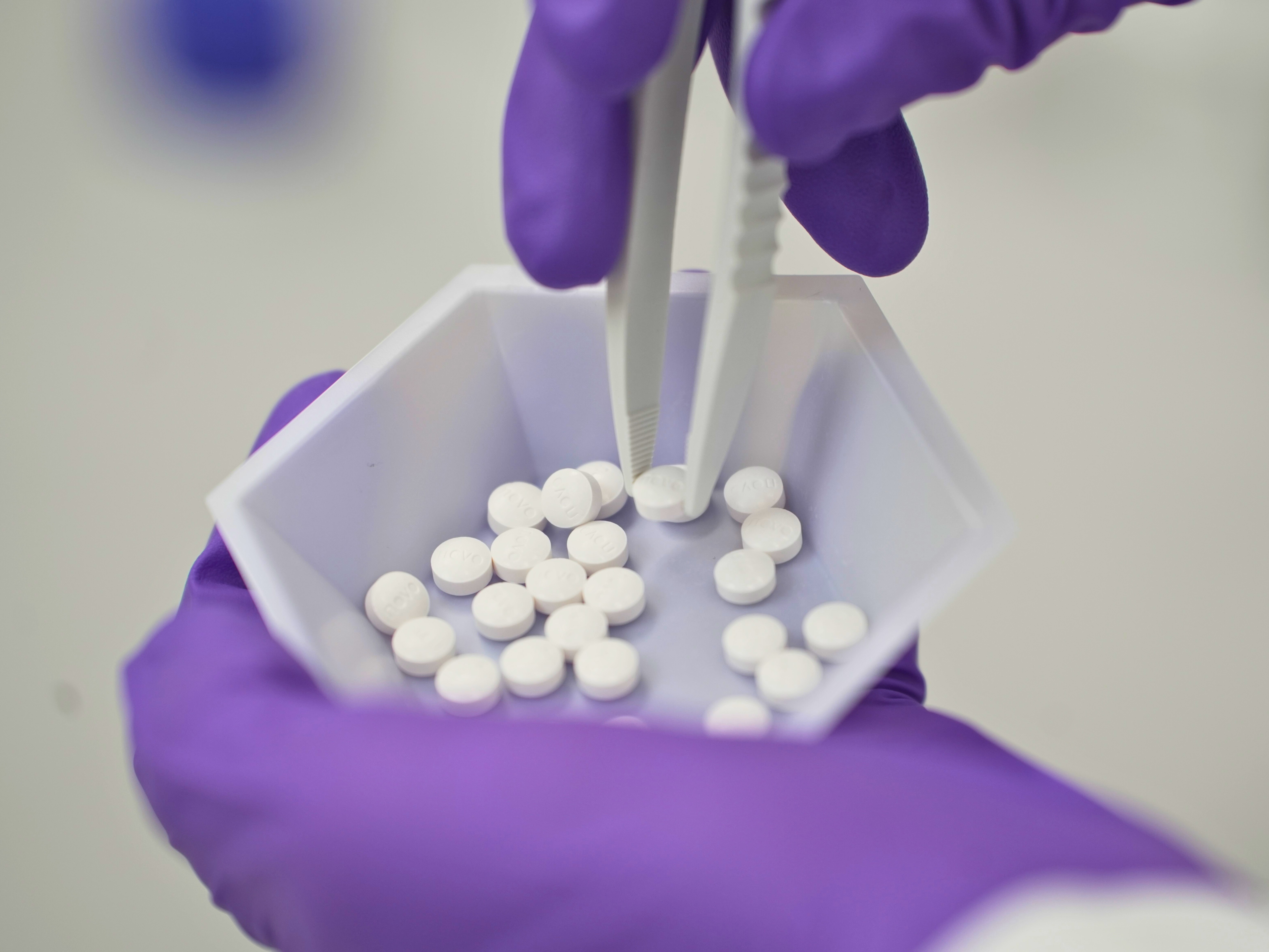 caption: A pill form of Wegovy, the popular obesity drug previously available only by injection, is now being stocked by pharmacies.