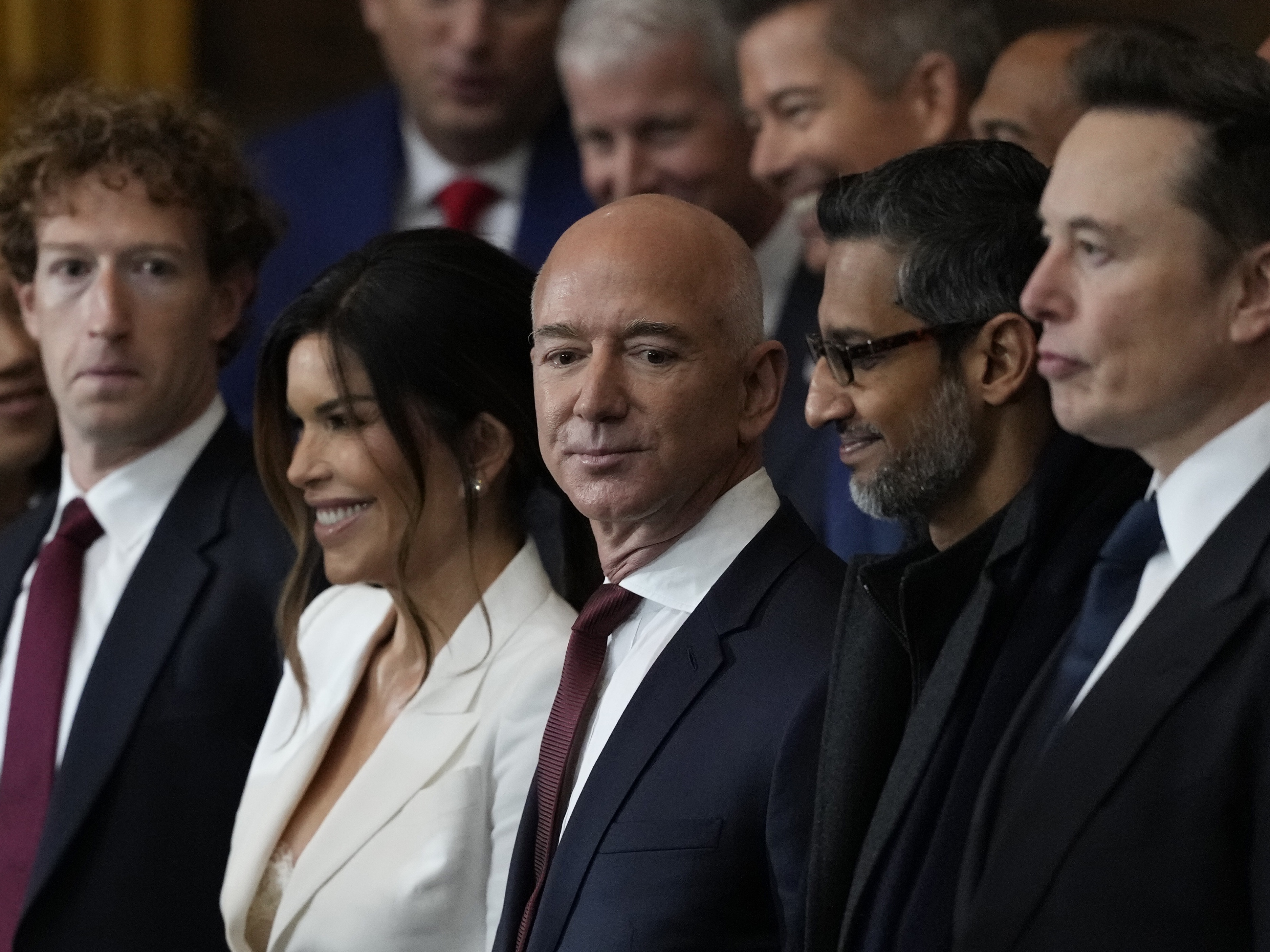 caption: Amazon founder and <em>Washington Post</em> owner Jeff Bezos, shown above next to his wife, Lauren Sanchez, and other digital titans, at the inauguration of President Trump in January, has written: "When it comes to the appearance of conflict, I am not an ideal owner of The <em>Post</em>." The<em> Post</em> has published several recent editorials that did not disclose they focused on matters in which Bezos had an interest.