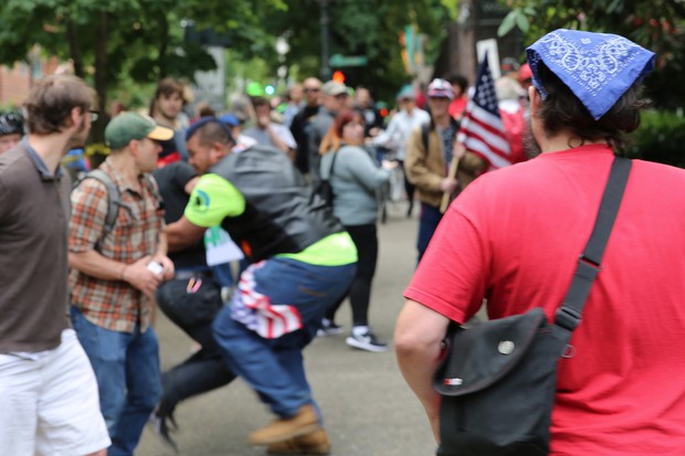 caption: <p>In 2017, Tusitala &ldquo;Tiny&rdquo; Toese, center, a known member of the militia style group, the Oath Keepers, was photographed tackling an Antifa protester before federal law enforcement officers detained the protester and arrested him.&nbsp;</p>