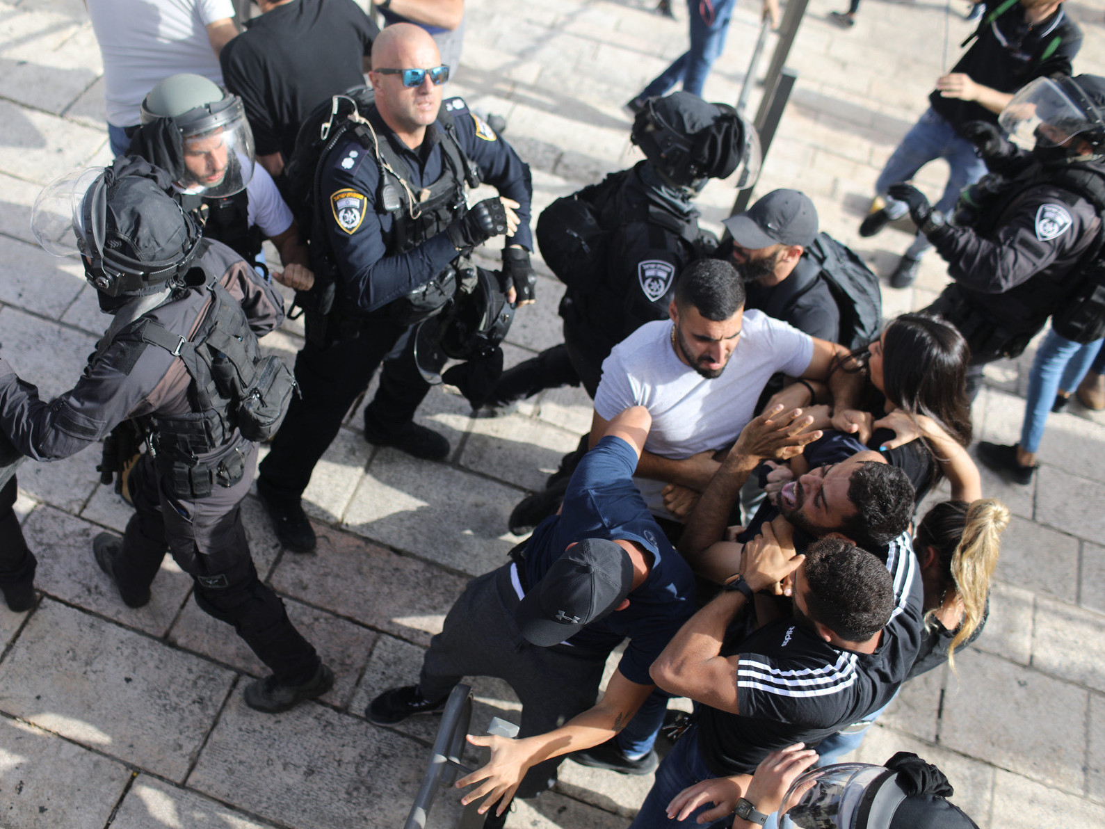 caption: Undercover Israeli security force members arrest a Palestinian protester at Damascus Gate in Jerusalem on Monday.