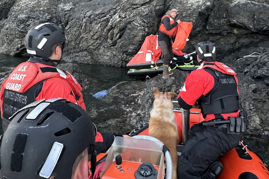 caption: Crew of the Coast Guard Cutter Adelie rescue fisherman Steve Zidell and his dog after the fishing vessel Chief Joseph sank off Henry Island, Washington, on May 3, 2024.