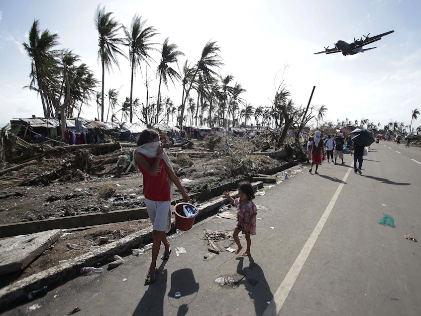 caption: Residents of Tacloban in the central Philippines in 2013, after Typhoon Haiyan devastated the area. Scientists are renewing calls for a new Category 6 designation for the the most powerful hurricanes and typhoons, such as Haiyan.