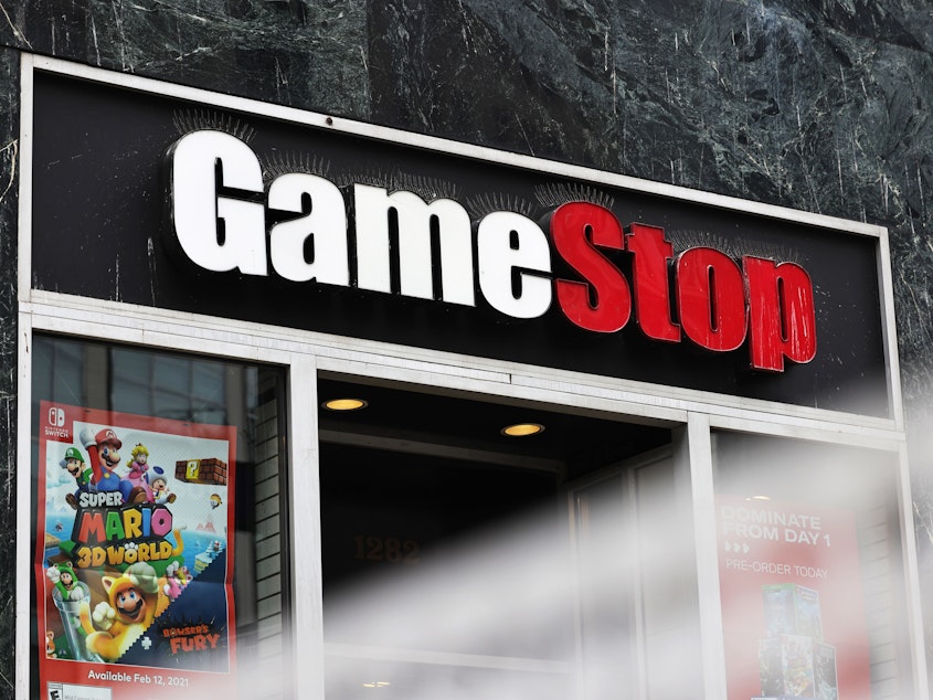caption: Shares of video game retailer GameStop shot up, the online broker Robinhood struggled for cash and securities regulators issued a stern warning for anyone trying to game the market.
