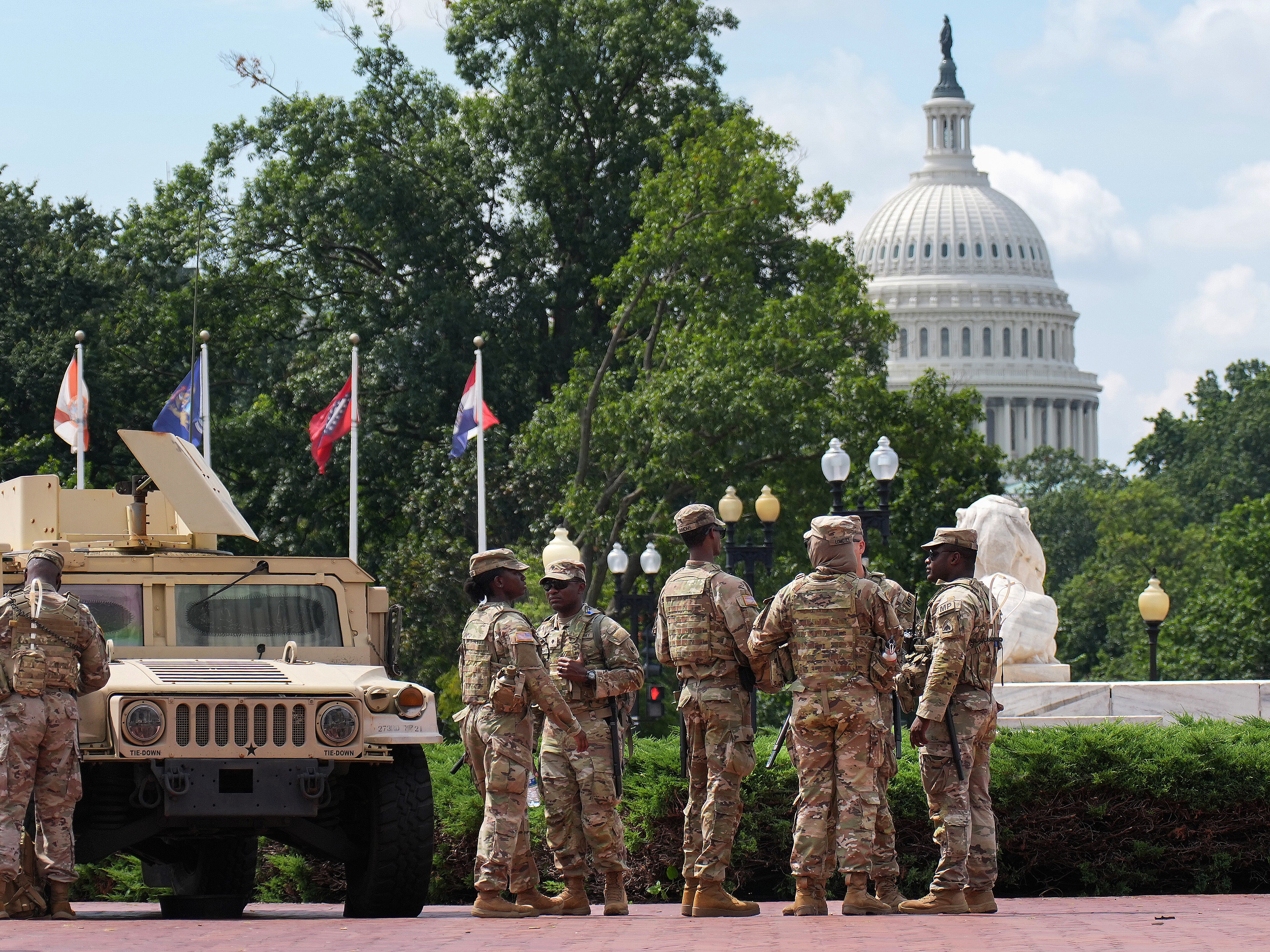 caption: Members of the National Guard stand near D.C.'s Union Station, within view of the U.S. Capitol, on Thursday.