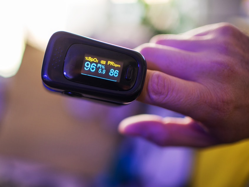 caption: A pulse oximeter provides a quick read on the saturation of oxygen in your blood. Some doctors believe it is a helpful device to have at home during the coronavirus pandemic. Others aren't so sure.