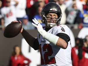 caption: Tampa Bay Buccaneers quarterback Tom Brady throws a pass against the Los Angeles Rams during the first half of an NFL divisional round playoff football game in January in Tampa, Fla. Brady's retirement lasted 40 days. He said Sunday, March 13, he is returning to the Buccaneers for his 23rd season in the NFL.