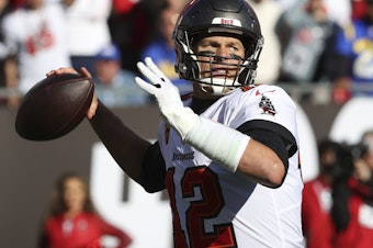 caption: Tampa Bay Buccaneers quarterback Tom Brady throws a pass against the Los Angeles Rams during the first half of an NFL divisional round playoff football game in January in Tampa, Fla. Brady's retirement lasted 40 days. He said Sunday, March 13, he is returning to the Buccaneers for his 23rd season in the NFL.