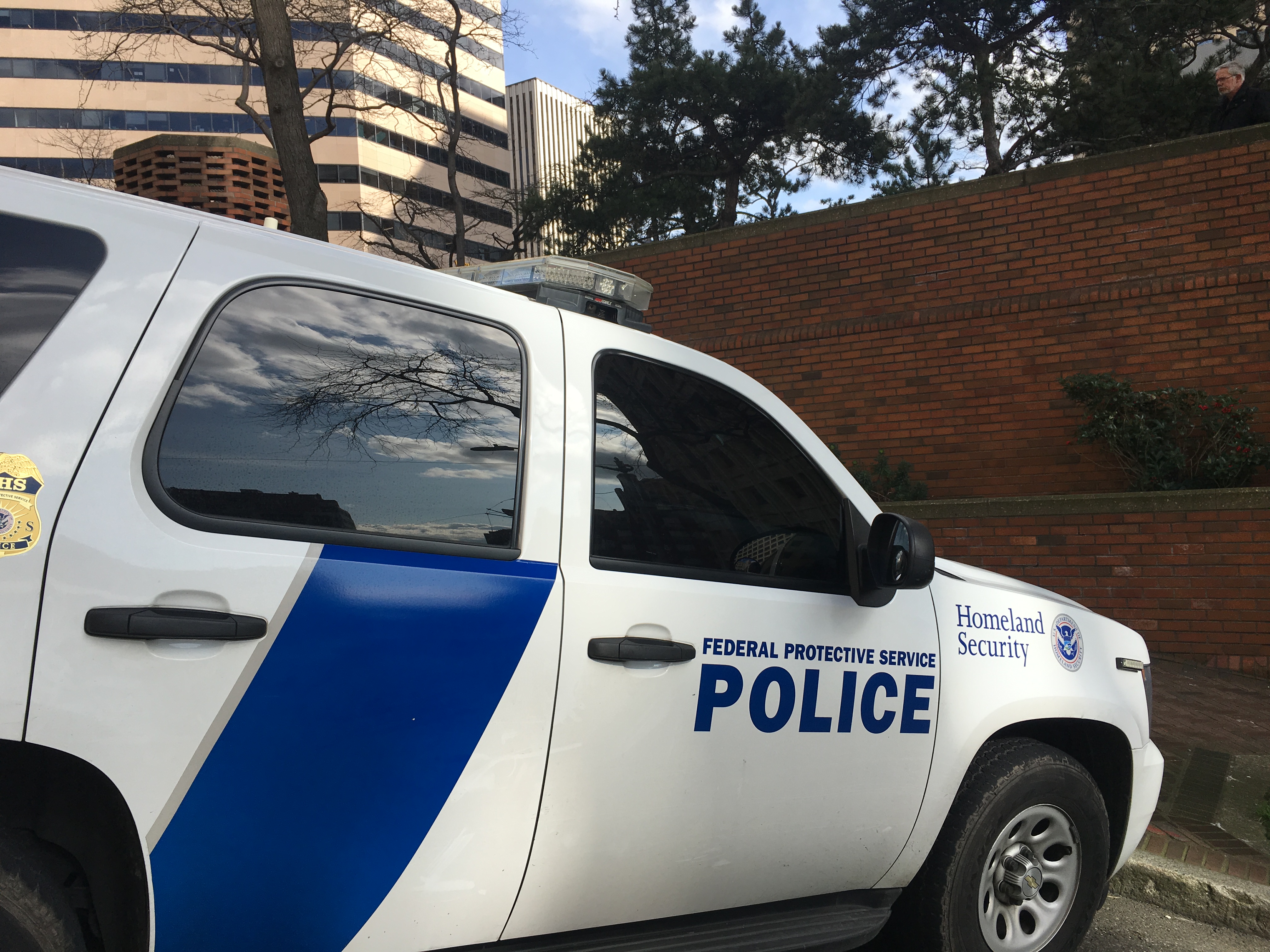 caption: Immigration and Customs Enforcement (ICE) vehicle in downtown Seattle
