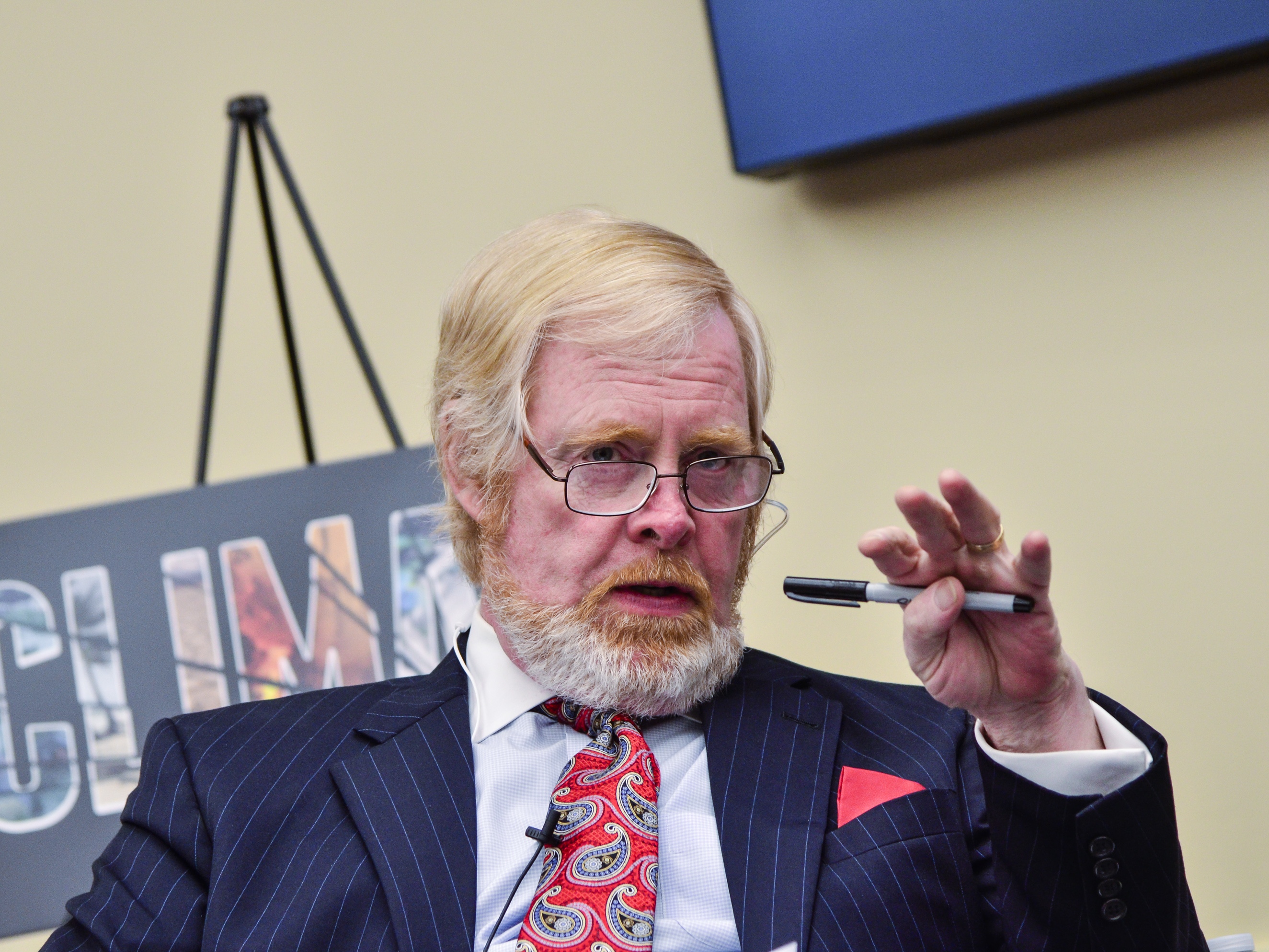 caption: President Trump says he wants L. Brent Bozell III, Founder and President of the Media Research Center, to lead the U.S. Agency for Global Media, or USAGM. In this 2016 photo, Bozell speaks during a "Climate Hustle" panel discussion at the Rayburn House Office Building in Washington, DC.