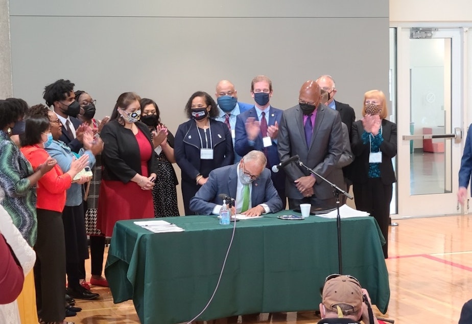 caption: Gov. Jay Inslee signed into law a suite of police accountability bills Tuesday at a bill signing ceremony in Tacoma.