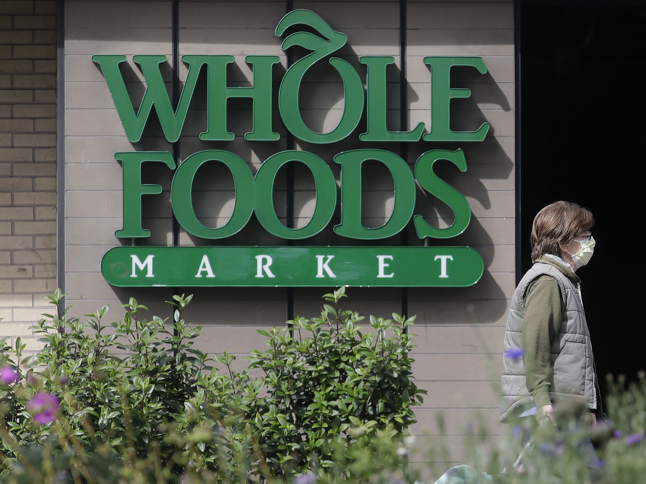 caption: Amazon, which owns Whole Foods, says it will devote some of the grocery chain's hours to online deliveries only.