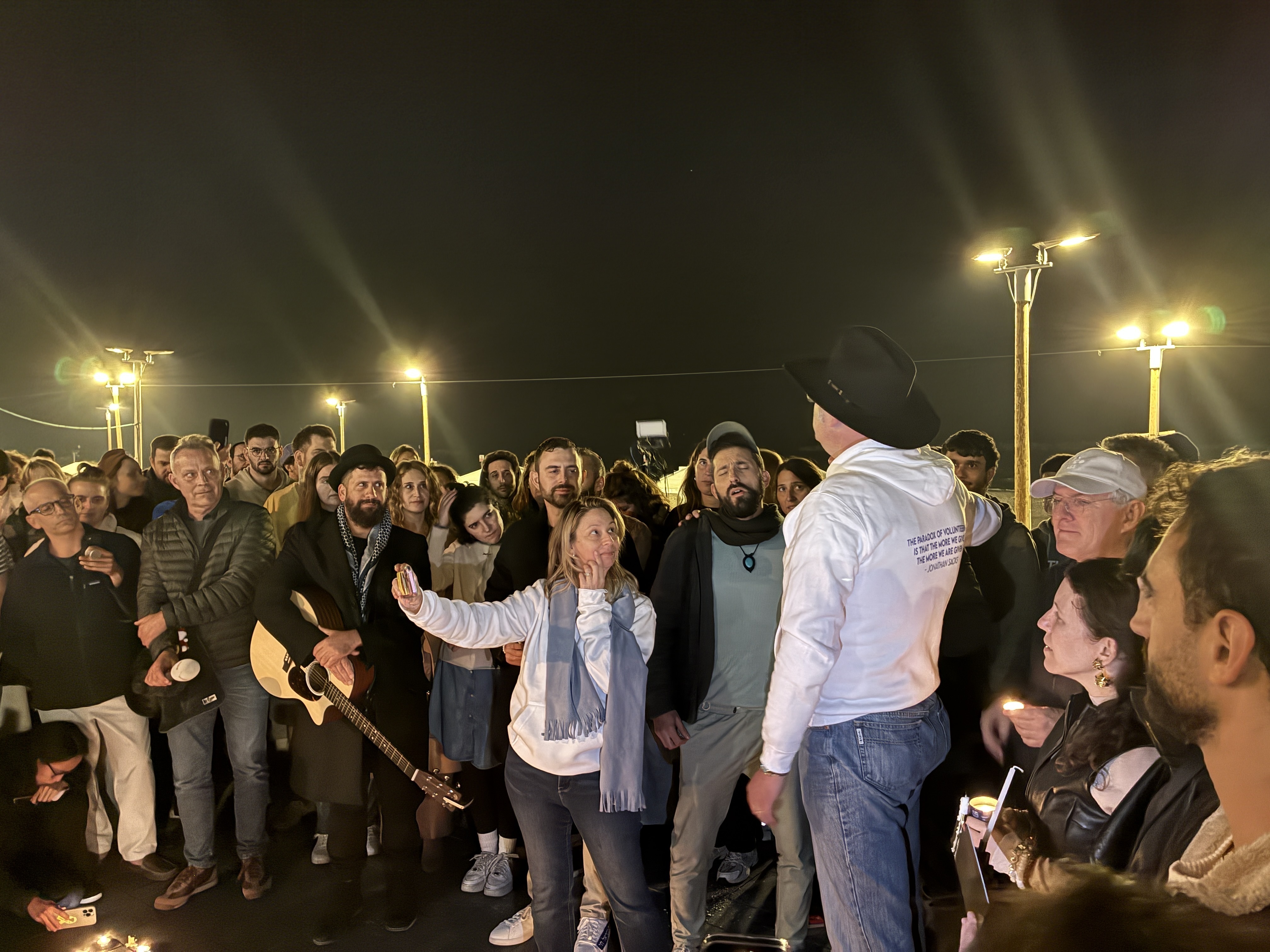 caption: Australian Jews and others hold a vigil in Tel Aviv for the victims of the Bondi Beach mass shooting, on Sunday, Dec 14.