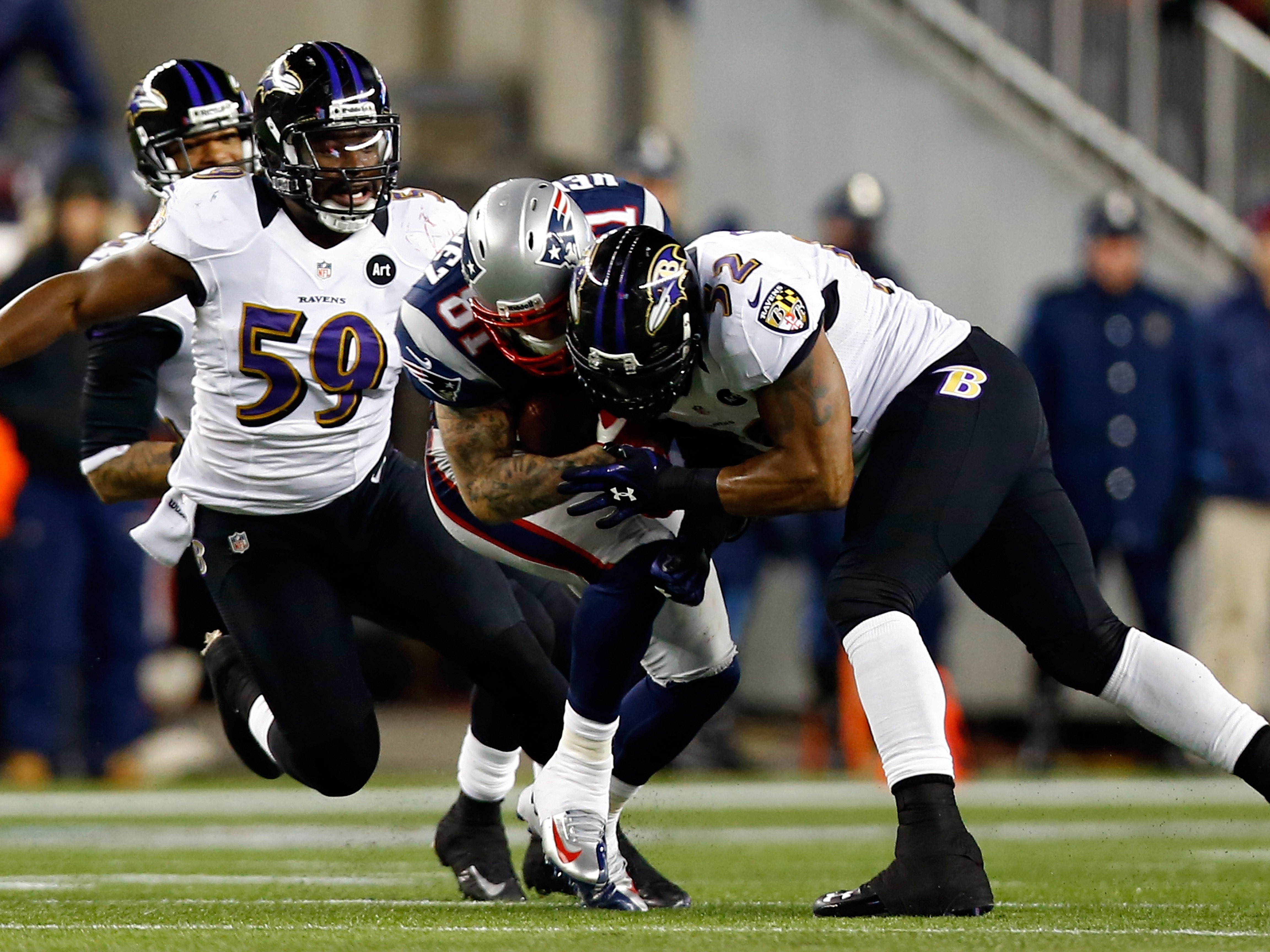 caption: Aaron Hernandez of the New England Patriots gets tackled with his helmet by Ray Lewis of the Baltimore Ravens during the 2013 AFC Championship game at Gillette Stadium on Jan. 20, 2013, in Foxboro, Mass. Hernandez died by suicide in 2017, and researchers found he had a severe case of CTE.
