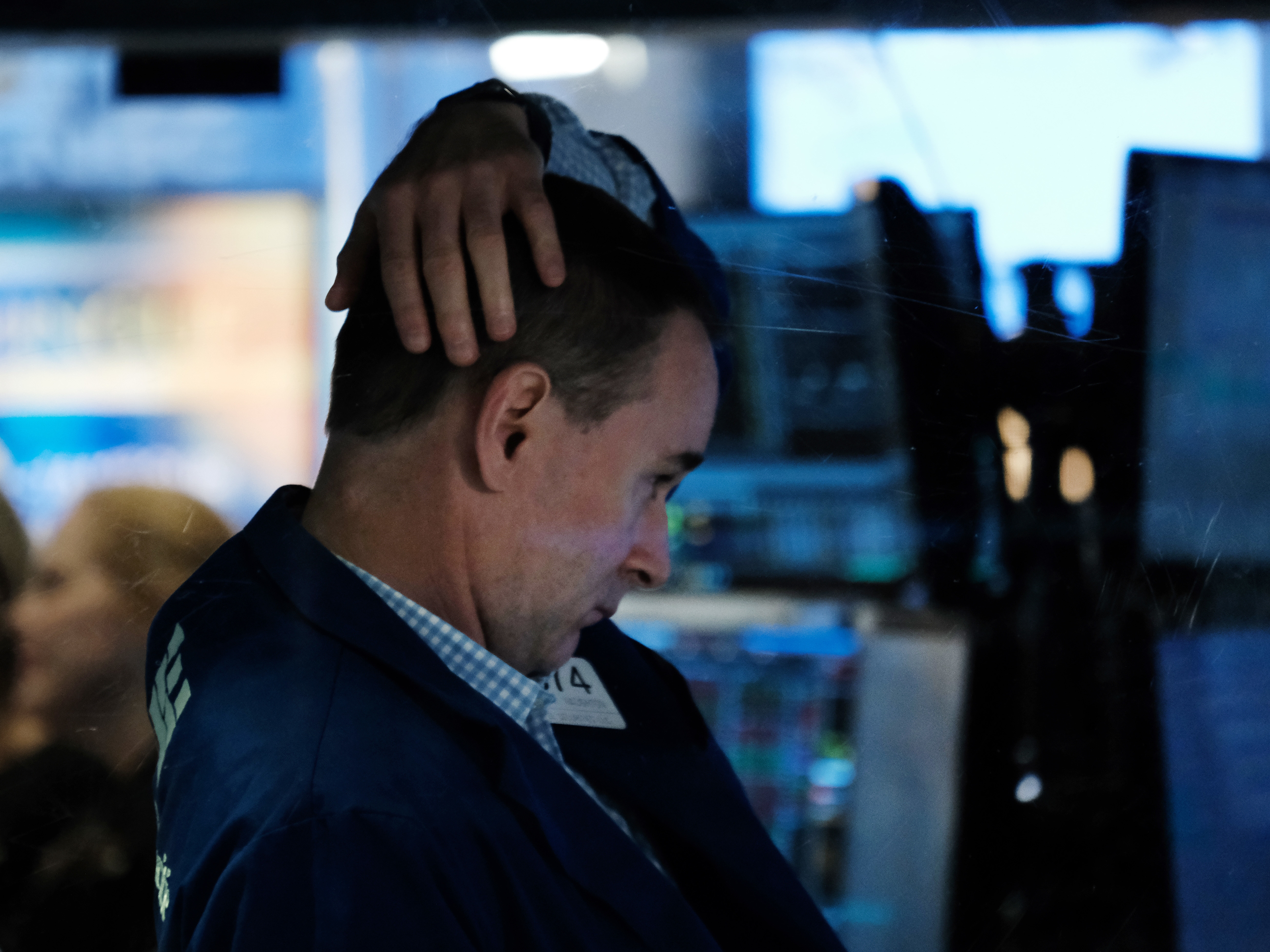 caption: A trader works on the floor of the New York Stock Exchange on Oct. 4, 2021, in New York City. Stocks and bonds have tumbled this year as a spike in inflation has investors bracing for higher interest rates.