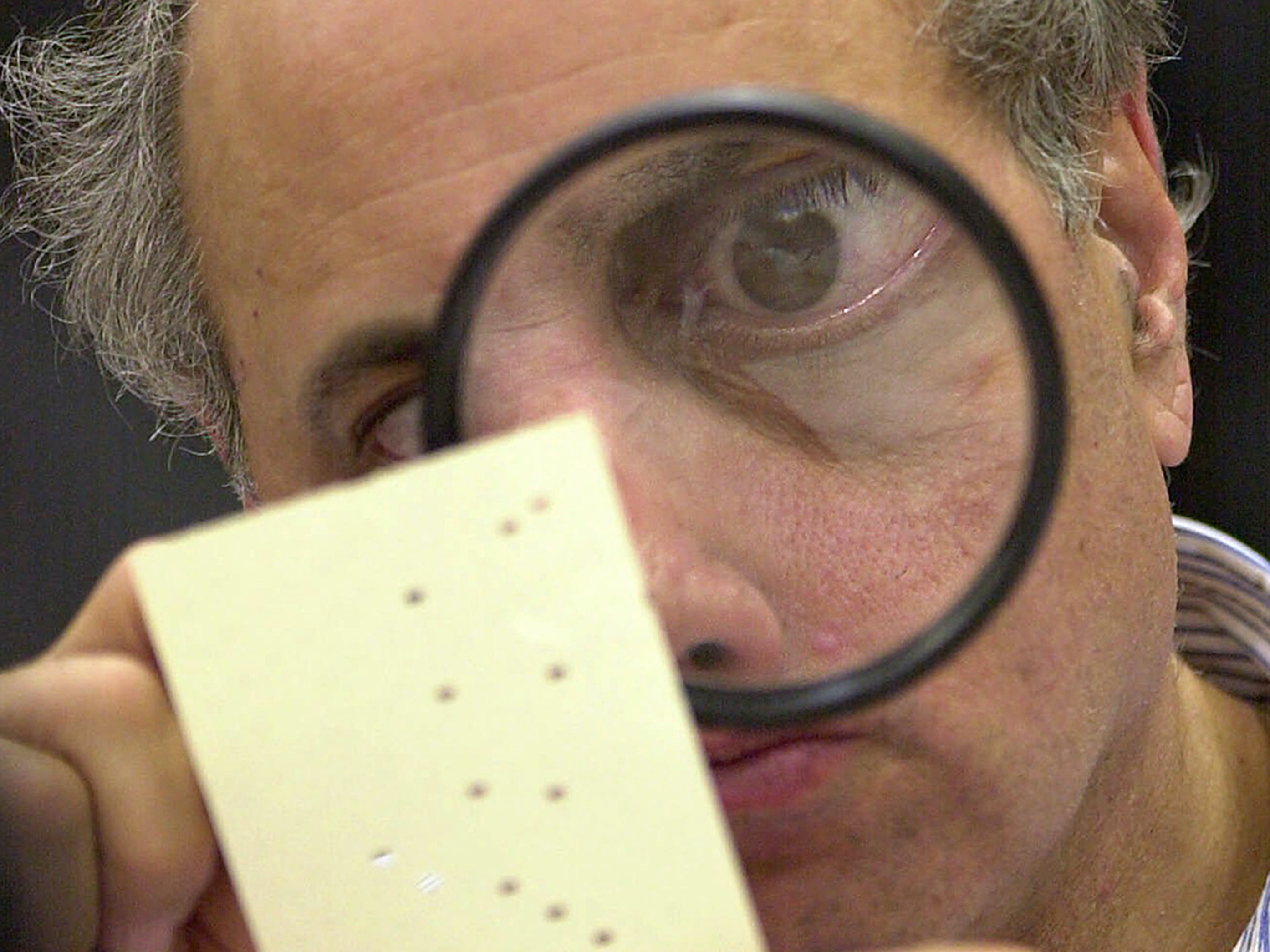 caption: Judge Robert Rosenberg, a member of the Broward County, Fla., canvassing board examines a disputed ballot in Fort Lauderdale, Fla., on Nov. 24, 2000. That close presidential contest was one of several in U.S. history.