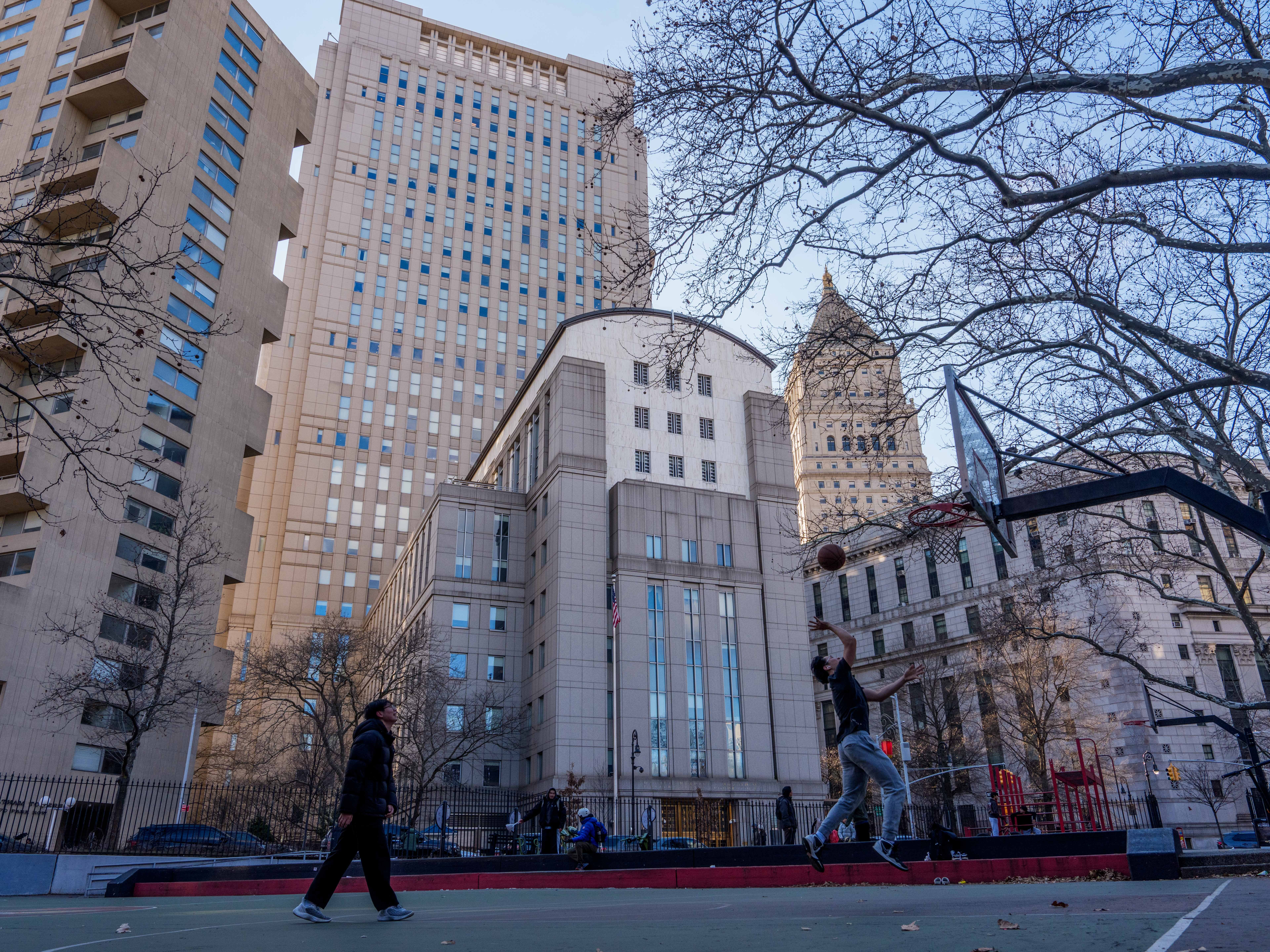 caption: People play basketball in front of Daniel Patrick Moynihan United States Courthouse in New York City on Sunday. Maduro is set to make his first court appearance on Monday.