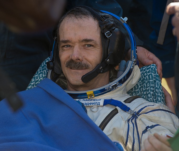 caption: Expedition 35 Commander Chris Hadfield of the Canadian Space Agency rests after his capsule landed in Kazakhstan on May 14, 2013.