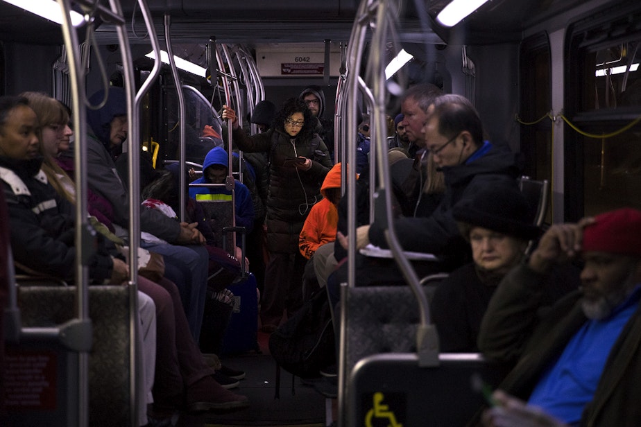 caption: Commuters ride the E Line bus southbound on Aurora Avenue North, around 5:30 a.m., on Wednesday, April 11, 2018, in Seattle.