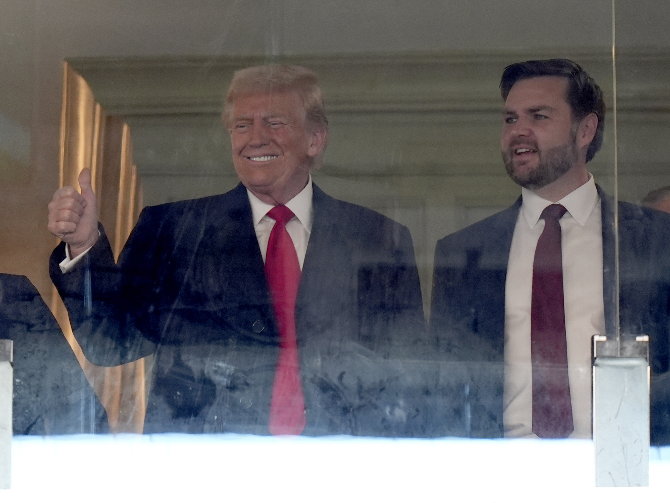 caption: President-elect Donald Trump, left, and Vice President-elect JD Vance attend the NCAA college football game between Army and Navy at Northwest Stadium in Landover, Md., on Saturday.
