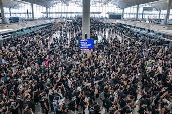 caption: Pro-democracy protesters occupy the departure hall of the Hong Kong International Airport, which was closed on Monday.