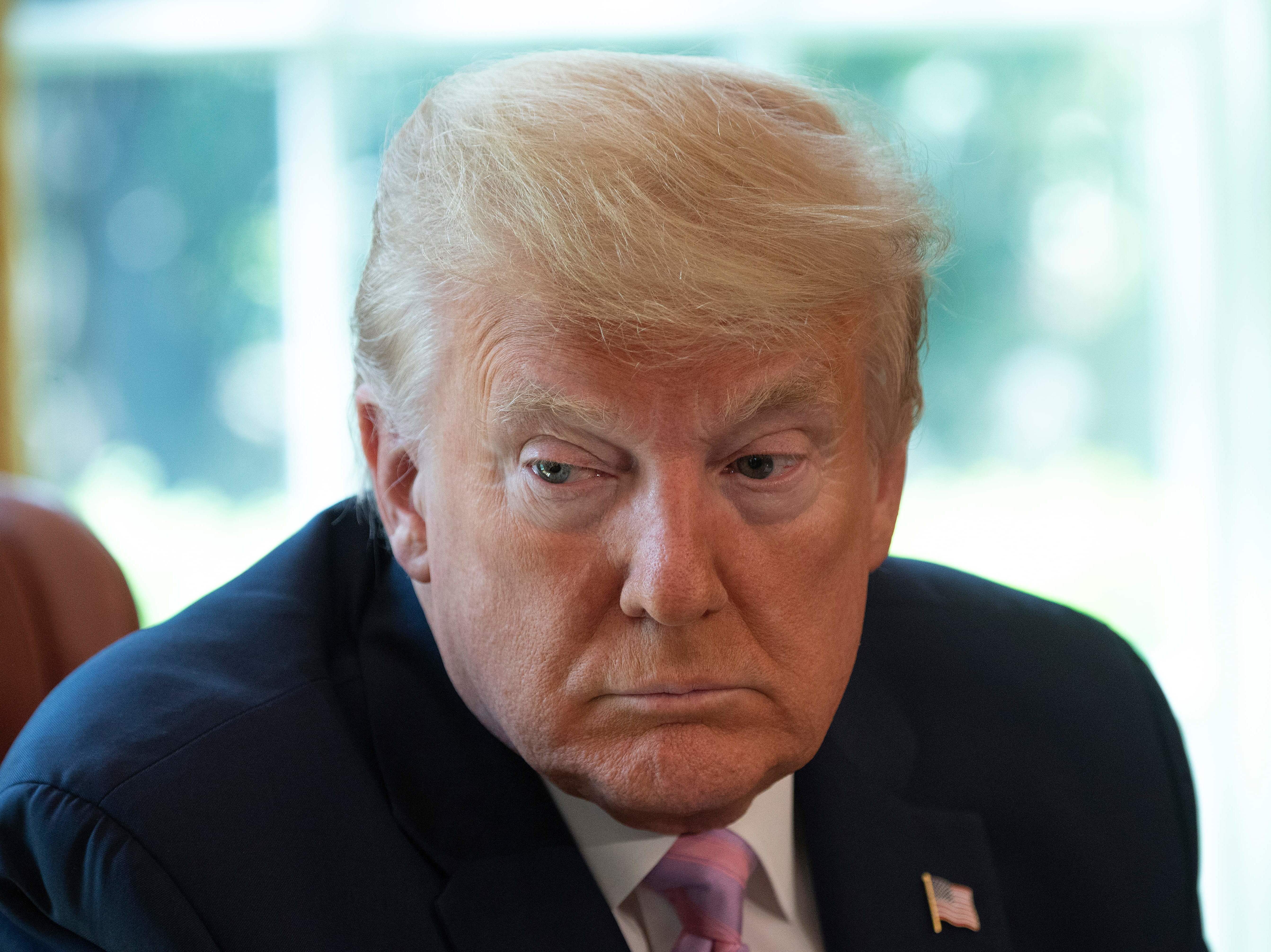 caption: President Trump, pictured during an Easter blessing in the Oval Office on Friday, is set to announce a new advisory council to help him decide when and how to reopen the country for business.
