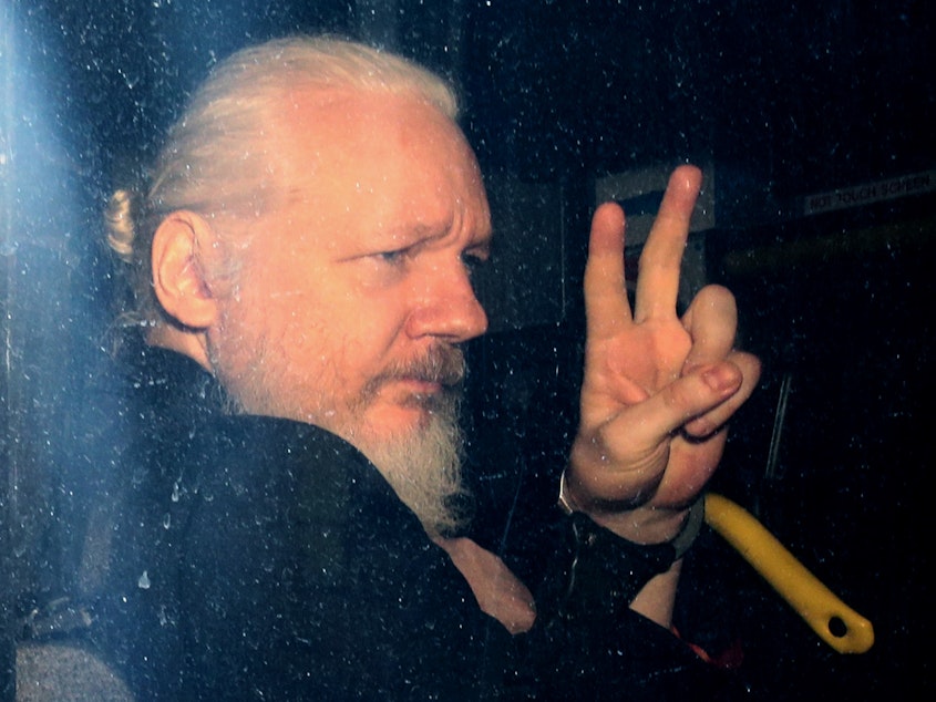 caption: WikiLeaks founder Julian Assange arrives in a police vehicle at Westminster Magistrates court on Thursday in London. He was arrested by Scotland Yard Police Officers inside the Ecuadorian Embassy in Central London.