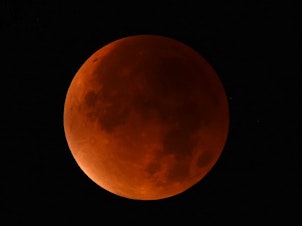 caption: A "blood moon" seen from western Germany during a total lunar eclipse on Sept. 28, 2015.