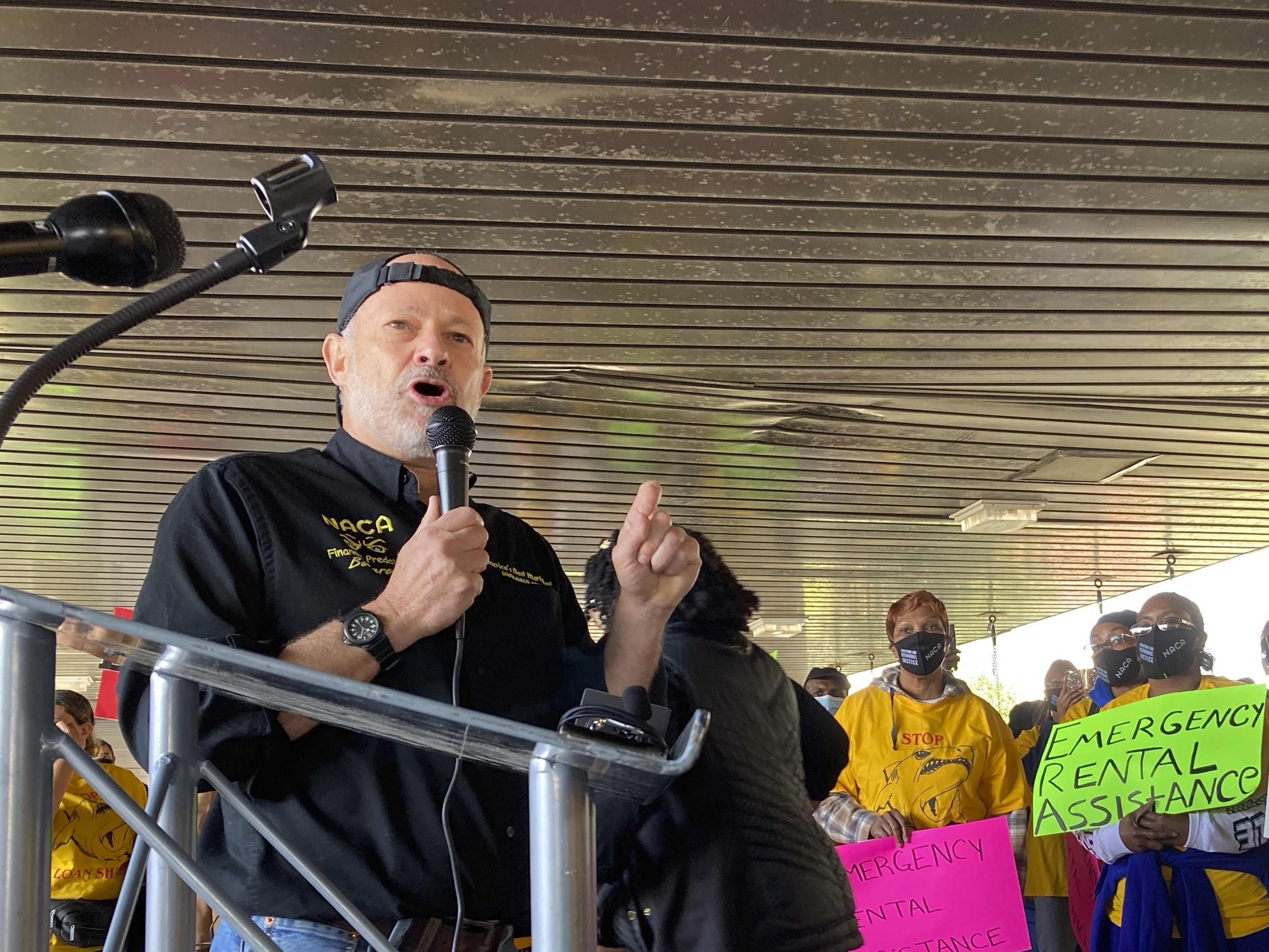 caption: Bruce Marks, CEO of the Neighborhood Assistance Corporation of America, speaks at a 2021 rally in Atlanta. The organization is requiring its 3.7 million members to vote.
