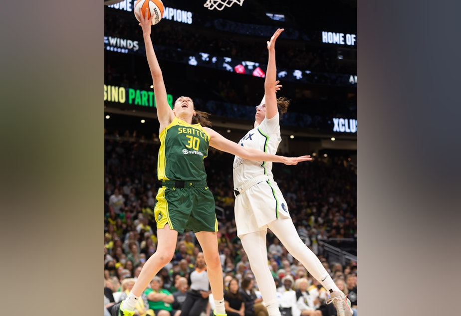 caption: Seattle's Storm's Breanna Stewart goes for two points against the Minnesota Lynx on Aug. 3, 2022.